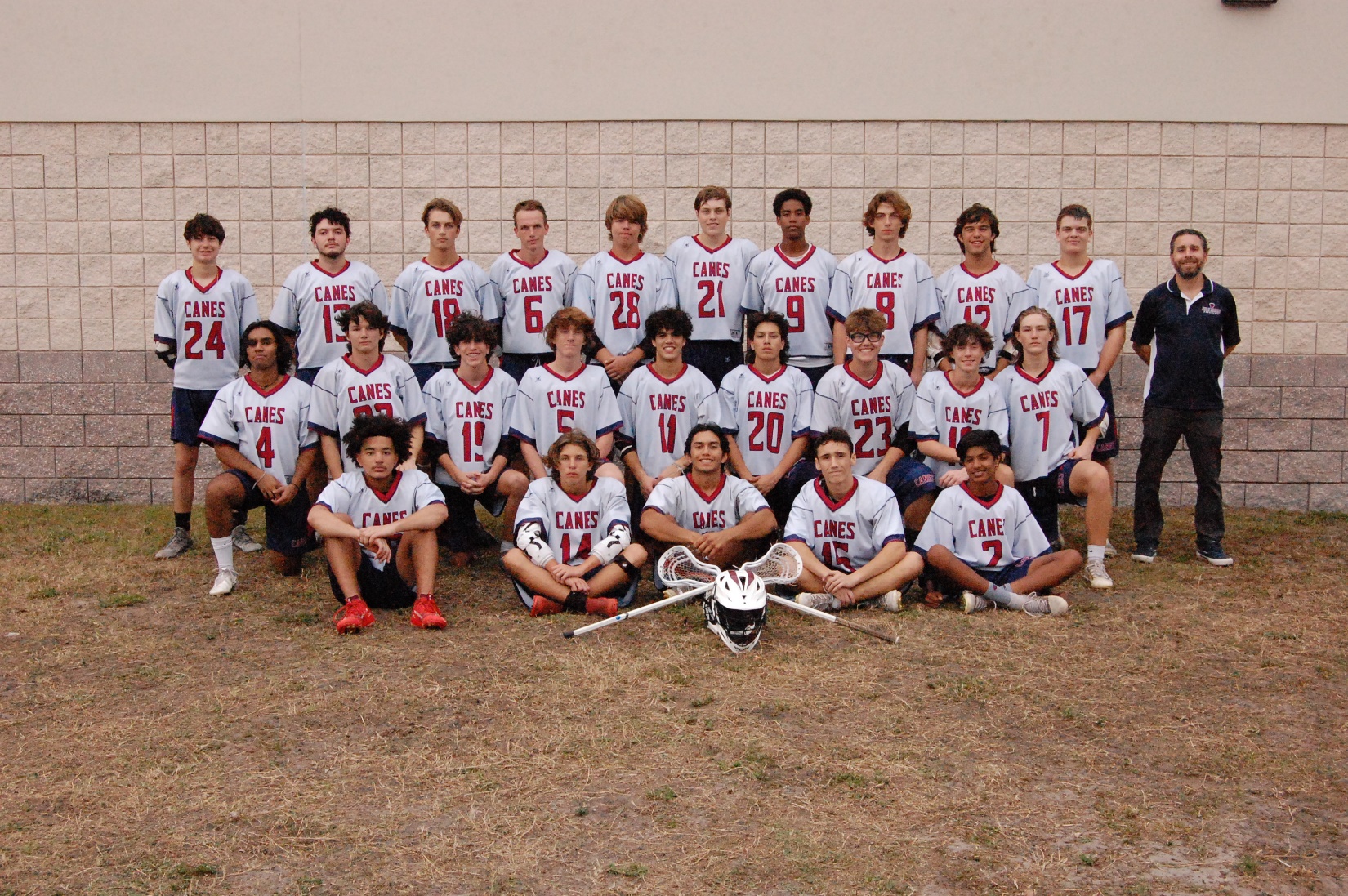 A group of people in sports uniforms posing for a photoDescription automatically generated